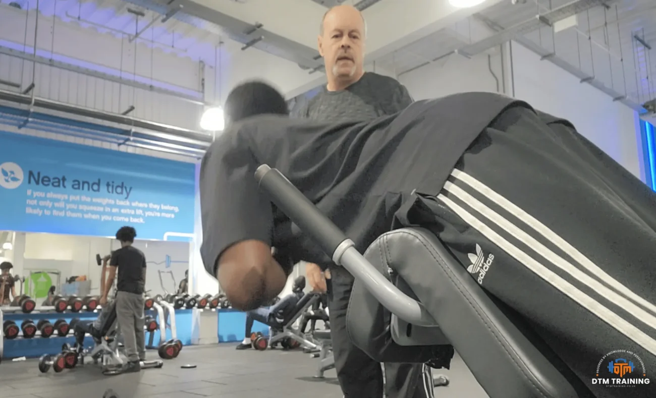 Daniel Batir coaching a client during a chest-supported back exercise in a one-to-one personal training session.