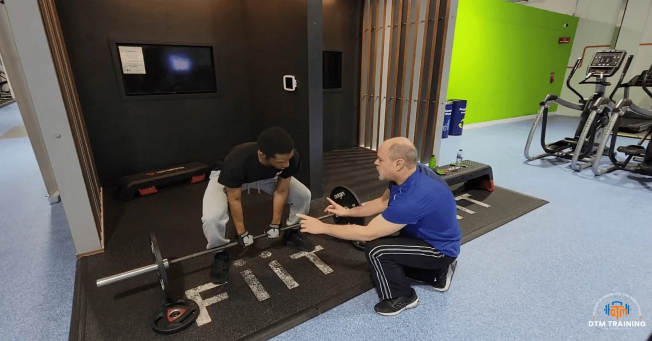 Daniel Batir coaching a client through deadlift technique during a one-to-one personal training session in London.