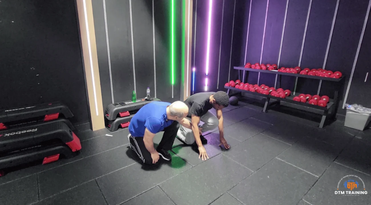 Daniel Batir coaching a client through a functional movement exercise during a personal training session in London.