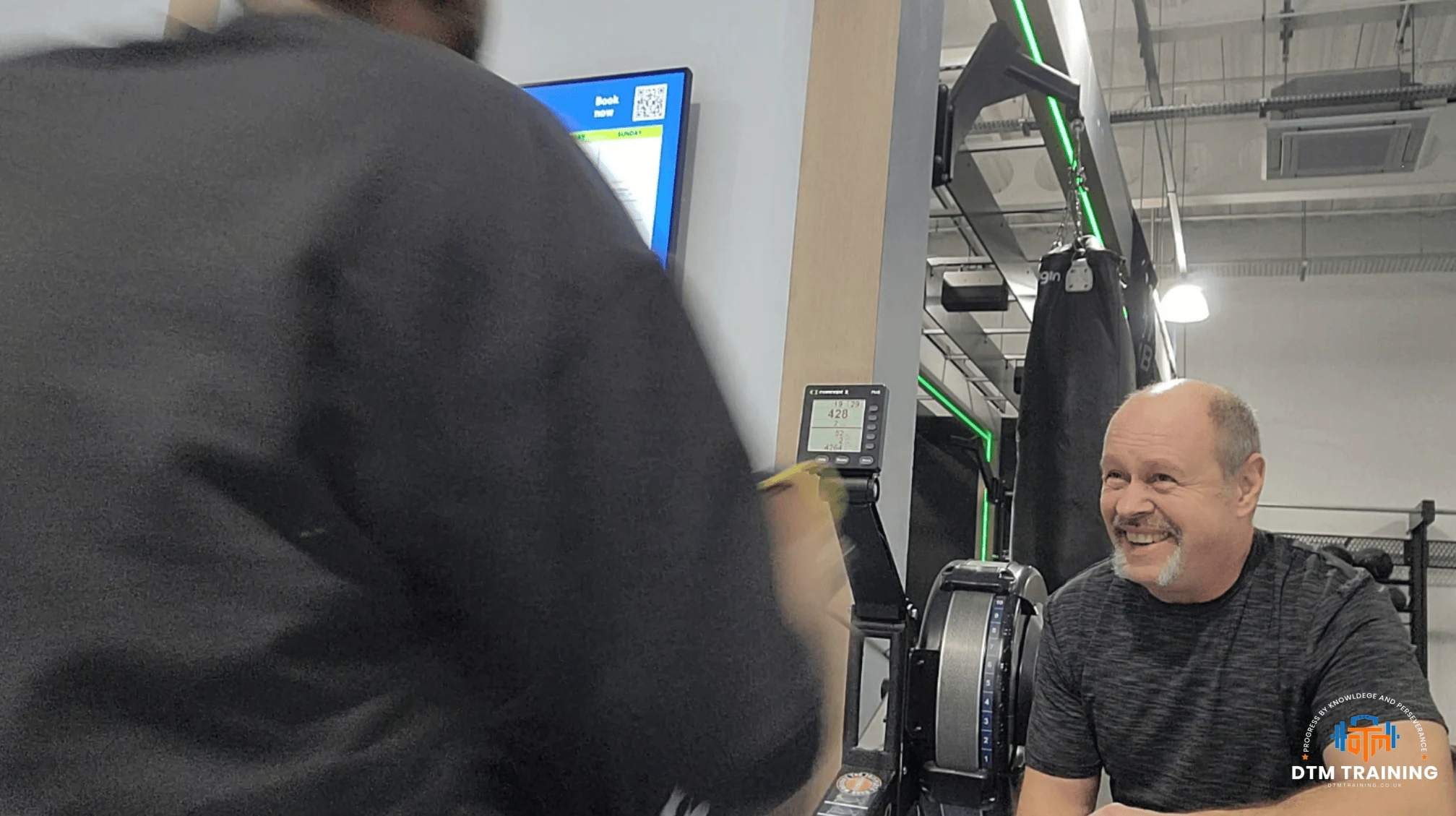Daniel Batir coaching a client during a personal training session in a London gym.